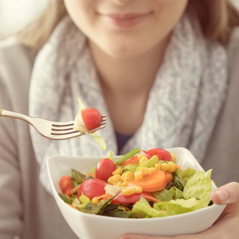 A person adopting a positive mindset toward healthy eating habits