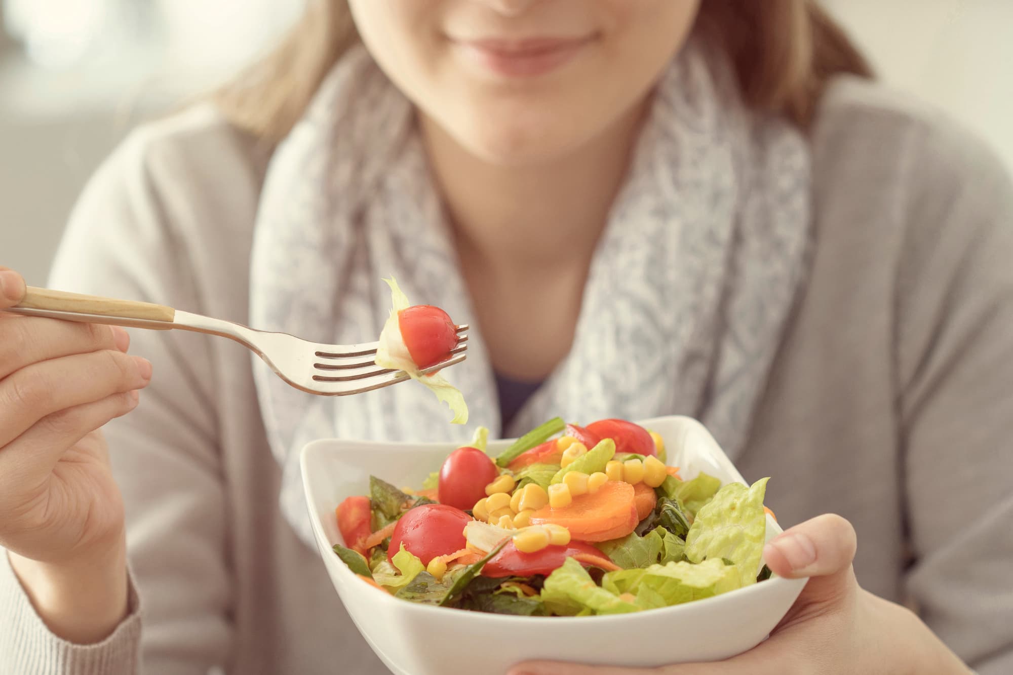 A person adopting a positive mindset toward healthy eating habits