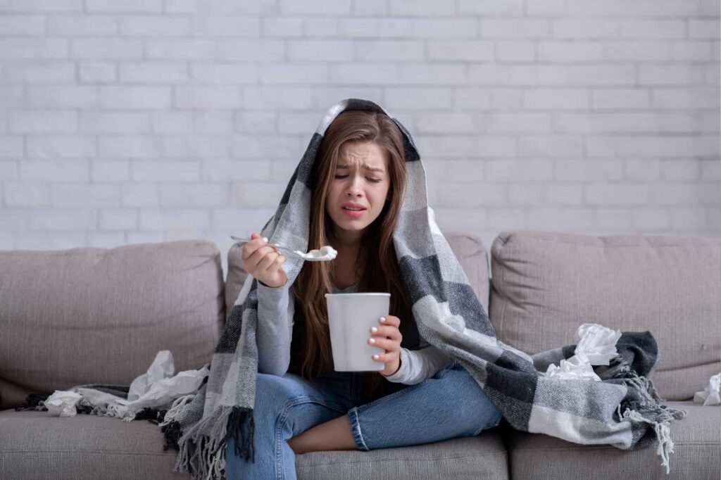 A stressed woman seeks solace in eating ice cream for its calming effect.