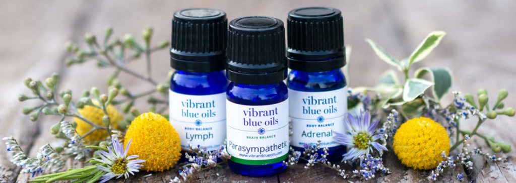 Vibrant Blue Oils – 3 bottles of blue essential oils with the names Lymph, Parasympathetic, and Adrenal.